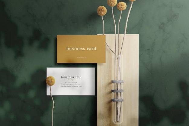 Clean minimal business card mockup on marble texture with branches and plants