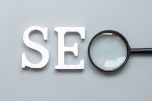 Seo (search engine optimization) text and magnifying glass on gray . idea, vision, strategy, analysis, keyword and content concept
