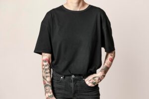 Tattooed model in black t shirt and jeans psd mockup