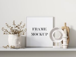 White picture frame beside interior accessories 3d rendering mockup