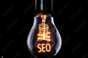Hanging lightbulb with glowing SEO concept