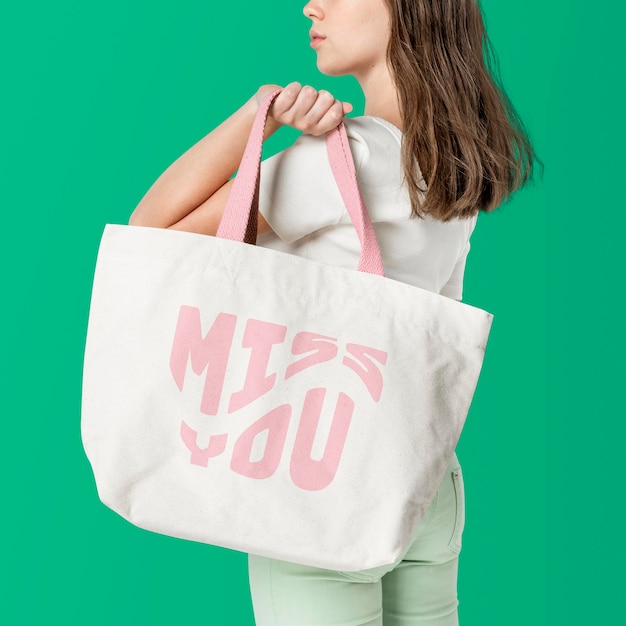 Beige tote bag mockup psd with pink miss you typography