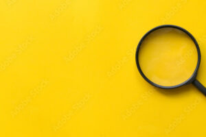 close up magnifier glass on yellow background