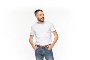 Closeup of young man's body in empty white t-shirt isolated on white background. clothing, mock up for disign concept with copy space. advertising concepts. front view