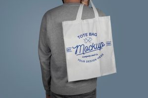 Mockup of model holding a tote bag on his back