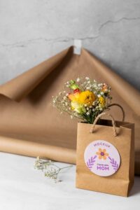 Mother's day mock-up with paper bag and flowers