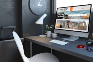 Navy desktop with travel accesories and agency website on computer 3d rendering mockup