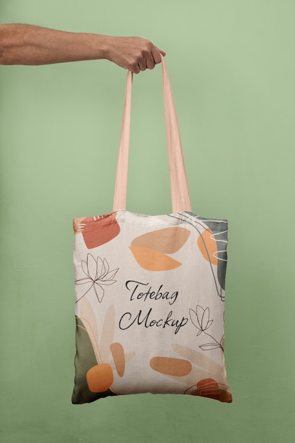 Side view of person holding tote bag mock-up