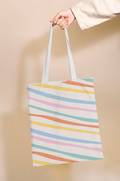Tote bag mockup psd with pastel stripes pattern