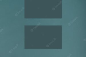 Blank business cards mockup on dark green background with eucalyptus branches top view