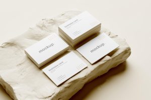 Business card mockup and stack perspective view with white rock