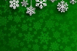 Christmas background with several hanging snowflakes on green background of small snowflakes