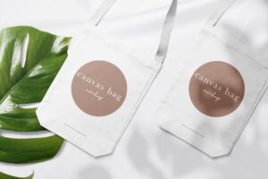 Clean minimal canvas bag mockup on cotton background with leaves