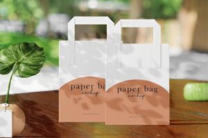 Clean minimal paper bag mockup on garden background with plant and vase