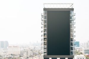 Empty black billboard on city and sky background advertising and public ad concept mock up 3d rendering