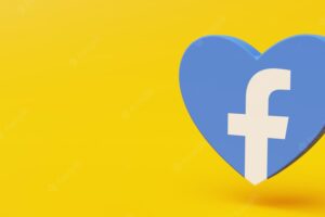 Facebook logo in the shape of a heart with orange background and copy space