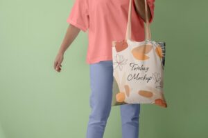 Front view of person holding tote bag mock-up