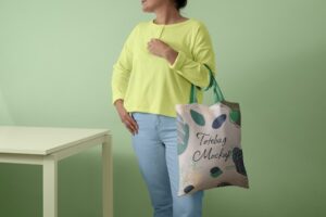 Front view of person holding tote bag mock-up