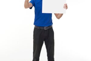 Handsome asian deliveryman holding mockup blank sign board isola