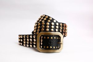 Mens studded leather belt with a metal buckle on white background