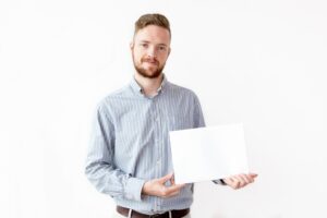 Portrait of confident businessman with blank paper