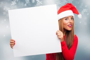 Woman with a sign in a snowflakes background