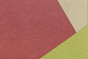 Texture of craft dark red color paper background with beige and green border vintage abstract wine cardboard