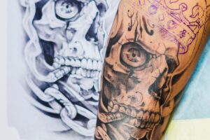 Arm with tattoo near the sketch