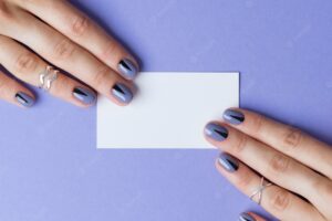 Female beautiful manicured hands with blank business card