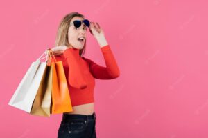 Girl with sunglasses holding shopping bags