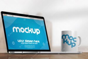 Mockup of mug and laptop in front of an office background