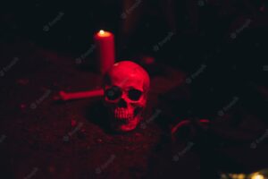 Skull and candle in a dark red light