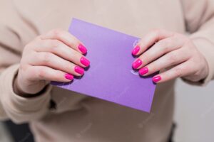 Woman holding a blank purple card in front of her
