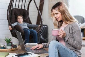 Beautiful mother enjoying working from home