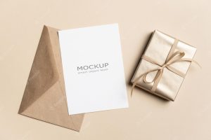 Blank greeting card mockup with golden gift box and envelope