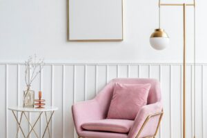 Blank picture frame by a pink velvet armchair