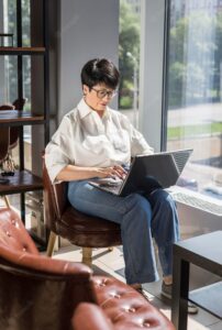 Businesswoman working on her laptop indoors