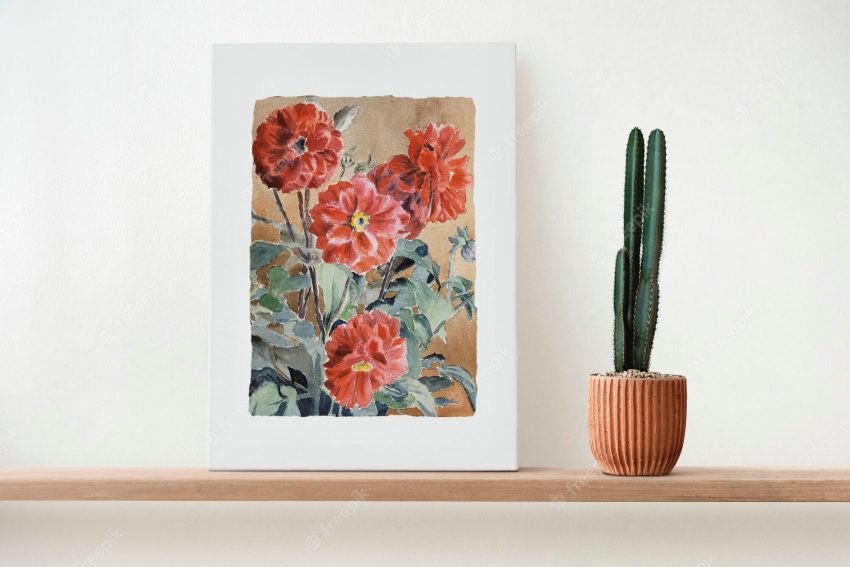 Canvas wall art on a wooden shelf with cactus