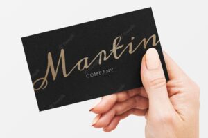 Classy business card in black and gold in a hand
