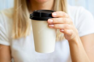 Close-up blonde woman with coffee cup