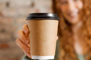Close up blurry woman holding cup