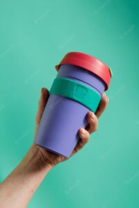 Close up on hand with reusable thermos