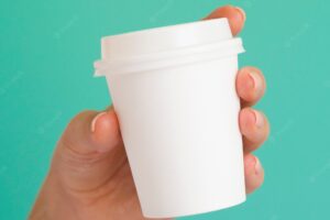 Close-up woman holding white coffee cup