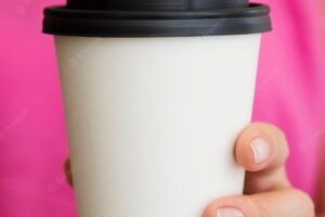 Close-up woman with pink shirt and coffee cup
