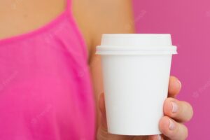 Close-up woman with pink shirt and cup