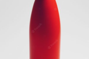 Closeup of reusable eco water bottle of red on white studio background