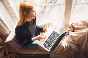 Cozy and warm. young woman using gadgets to watch cinema, photos, online courses, taking selfie or vlog, online shopping or surfing. reading news, has online conference, education, meeting friends.