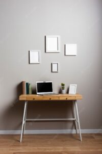 Desk design with laptop and frames mock-up