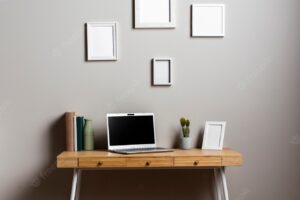 Desk design with laptop and frames mock-up