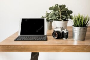 Desktop with laptop and photo camera